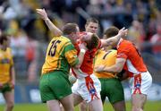 12 June 2005; Francie Bellew, Armagh, is held back by Donegal's Adrian Sweeney. Bank of Ireland Ulster Senior Football Championship Semi-Final, Donegal v Armagh, St. Tighernach's Park, Clones, Co. Monaghan. Picture credit; Damien Eagers / SPORTSFILE