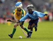 12 June 2005; Damilola Sanusi, age 9, from Scoil Mhuire na nGael, Bay Estate, Dundalk, Co. Louth, in action against Patrick Reid, left, age 8, from Scoil an Leinbh êosa, Donegal Town, Co. Donegal, during the half-time GAA 'Go Games' First Touch hurling exhibition match, Guinness Leinster Senior Hurling Championship Semi-Final, Kilkenny v Offaly, Croke Park, Dublin. Picture credit; Matt Browne / SPORTSFILE