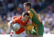 12 June 2005; Ronan Clarke, Armagh, in action against Raymond Sweeney, Donegal. Bank of Ireland Ulster Senior Football Championship Semi-Final, Donegal v Armagh, St. Tighernach's Park, Clones, Co. Monaghan. Picture credit; Damien Eagers / SPORTSFILE
