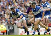 12 June 2005; Seamus Dwyer, Laois, supported by team-mate Darren Rooney, is tackled by Redmond Barry, Wexford. Guinness Leinster Senior Hurling Championship Semi-Final, Wexford v Laois, Croke Park, Dublin. Picture credit; Matt Browne / SPORTSFILE