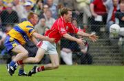 12 June 2005; Conor McCarthy, Cork, in action against Ronan Slattery, Clare. Bank of Ireland Munster Senior Football Championship Semi-Final, Clare v Cork, Cusack Park, Ennis, Co. Clare. Picture credit; Kieran Clancy / SPORTSFILE