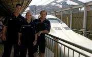 13 June 2005; Members of the Irish rugby squad, David Quinlan, left, Peter Stringer and Frankie Sheahan, right, next to the Shinkansen (Bullet Train) on the platform at Shin Osaka Railway station before travelling to Tokyo for next Sunday's second test with Japan. Shin Osaka station, Osaka, Japan. Picture credit; Brendan Moran / SPORTSFILE