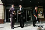 13 June 2005; Kildare Footballer John Doyle, left, and Waterford hurler Eoin Kelly, who were presented with the Vodafone Player of the Month awards for the month of May, outside the Westbury Hotel with Hotel Commisionaire Ronan Butler. Westbury Hotel, Dublin Picture credit; David Maher / SPORTSFILE