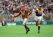 11 July 1993; Eammon Morrissey of Kilkenny in action against John O'Connor of Wexford during the Leinster Senior Hurling Championship Final match between Kilkenny and Wexford at Croke Park in Dublin. Photo by Ray McManus/Sportsfile