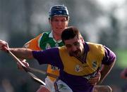 23 March 1997; Martin Storey of Wexford in action against Hubert Rigney of Offaly during the National Hurling League Division 1 match between Offaly and Wexford at St. Brendan's Park in Birr, Offaly. Photo by David Maher/Sportsfile