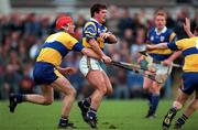 10 May 1997; Michael Cleary of Tipperary in action against Brian Lohan, left, with Ollie Baker of Clare during the National Hurling League Division 1 match between Clare and Tipperary at Cusack Park in Ennis, Clare. Photo by Ray McManus/Sportsfile