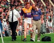 17 August 1997; Rod Guiney Wexford is helped off the pitch by the Wexford team doctor during the GAA All-Ireland Senior Hurling Championship Semi-Final match between Tipperary and Wexford at Croke Park in Dublin. Photo by David Maher/Sportsfile