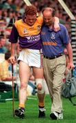 17 August 1997; Rod Guiney Wexford is helped off the pitch by the Wexford team doctor during the GAA All-Ireland Senior Hurling Championship Semi-Final match between Tipperary and Wexford at Croke Park in Dublin. Photo by David Maher/Sportsfile