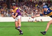17 August 1997; Rory McCarthy of Wexford  in action against Conal Bonner of Tipperary during the GAA All-Ireland Senior Hurling Championship Semi-Final match between Tipperary and Wexford at Croke Park in Dublin. Photo by David Maher/Sportsfile