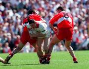29 June 1997; Stephen Lawn of Tyrone in action against David O'Neill and Anthony Tohill of Derry during the Ulster GAA Football Senior Championship Semi-Final match between Tyrone and Derry at St. Tiernach's Park in Clones, Monaghan. Photo by David Maher/Sportsfile