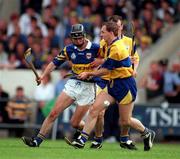 6 July 1997; Thomas Dunne of Tipperary in action against Liam Doyle of Clare during the Guinness Munster Senior Hurling Championship Final match between Clare and Tipperary at Páirc Uí Chaoimh in Cork. Photo by Ray McManus/Sportsfile