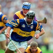 17 August 1997; Thomas Dunne of Tipperary in action against Eugene Furlong of Wexford during the GAA All-Ireland Senior Hurling Championship Semi-Final match between Tipperary and Wexford at Croke Park in Dublin. Photo by David Maher/Sportsfile