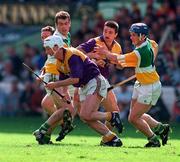 22 June 1997; Tom Dempsey of Wexford breaks the tackle by Kevin Martin and Hubert Rigney of Offaly during the GAA Leinster Senior Hurling Championship Semi-Final match between Wexford and Offaly at Croke Park in Dublin. Photo by Ray McManus/Sportsfile