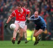 28 March 1999; Ciaran O'Sullivan of Cork in action against Brian Stynes of Dublin during the Church and General National Football League Division 1 match between Cork and Dublin at Páirc Uí Rinn in Cork. Photo by Damien Eagers/Sportsfile