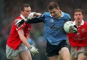 28 March 1999; Dessie Farrell of Dublin is tackled by Michael O'Donovan of Cork during the Church and General National Football League Division 1 match between Cork and Dublin at Páirc Uí Rinn in Cork. Photo by Brendan Moran/Sportsfile