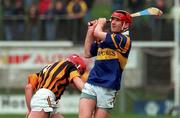 28 March 1999; Eddie Tucker of Tipperary in action against Johnny Butler of Kilkenny during the Church and General National Hurling League Division 1B match between Kilkenny and Tipperary at Nowlan Park in Kilkenny. Photo by Matt Browne/Sportsfile