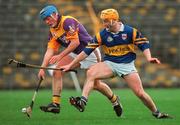 21 March 1999; Eugene Furlong of Wexford in action against Liam Cahill of Tipperary during the Church and General National Hurling League Division 1B match between Tipperary and Wexford at Semple Stadium in Thurles, Tipperary. Photo by Ray McManus/Sportsfile