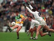 6 April 1997; Sean Grennan of Offaly in action against John FInn and Glenn Ryan of Kildare during the Church and General National Football League Quarter-Final match between Offaly and Kildare at Páirc Tailteann in Navan, Meath. Photo by Ray McManus/Sportsfile