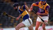 21 March 1999; Thomas Dunne of Tipperary in against Eugene Furlong of Wexford during the Church and General National Hurling League Division 1B match between Tipperary and Wexford at Semple Stadium in Thurles, Tipperary. Photo by Damien Eagers/Sportsfile
