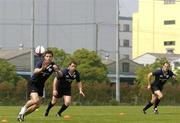 14 June 2005; Centre David Quinlan receives a pass, watched by team-mates Marcus Horan and Girvan Dempsey, right, during training. Ireland rugby squad training, Tatsumi No Mori Rugby training facility, Tokyo, Japan. Picture credit; Brendan Moran / SPORTSFILE