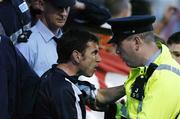 17 June 2005; Pat Fenlon, Shelbourne manager, reacts with a Garda at the end of the game. eircom League, Premier Division, Shelbourne v Shamrock Rovers, Tolka Park, Dublin. Picture credit; David Maher / SPORTSFILE