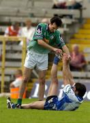18 June 2005; Shane McInerney, London, helps Damien Freeman, Monaghan, to relieve his cramp late in the game. Bank of Ireland All-Ireland Senior Football Championship Qualifier, Round 1, Monaghan v London, St. Tighernach's Park, Clones, Co. Monaghan. Picture credit; Pat Murphy / SPORTSFILE