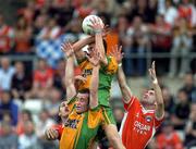 18 June 2005; Eamonn McGee and John McEntee, bottom, Donegal, in action against Steven McDonnell, right, and John McEntee, Armagh. Bank of Ireland Ulster Senior Football Championship Replay, Armagh v Donegal, St. Tighernach's Park, Clones, Co. Monaghan. Picture credit; Pat Murphy / SPORTSFILE