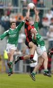 18 June 2005; Dan Gordon, Down, in action against Eamon Maguire, left, and Martin McGrath, Fermanagh. Bank of Ireland All-Ireland Senior Football Championship Qualifier, Round 1, Down v Fermanagh, Pairc an Iuir, Newry, Co. Down. Picture credit; David Maher / SPORTSFILE