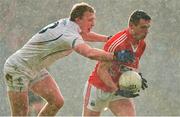9 February 2014; John O'Rourke, Cork, in action against Tommy Moolick, Kildare, during a hail shower. Allianz Football League Division 1 Round 2, Cork v Kildare, Páirc Uí RInn, Cork. Picture credit: Matt Browne / SPORTSFILE