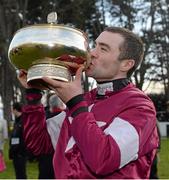 9 February 2014; Jockey Brian O'Connell kisses the Gold Cup after victory in The Hennessy Gold Cup on Last Instalment. Leopardstown Racecourse, Leopardstown, Co. Dublin. Picture credit: Barry Cregg / SPORTSFILE