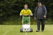 17 June 2005; Special Olympics Athlete Robert Coone, Cheeverstown, assists groundsman Mick Burke, as they mark the lines before the start of the game. Special Olympics Ireland Leinster / Eastern Regional Games 2005, Stillorgan Rangers  v Bray Lakers. AUL Complex, Clonshaugh, Dublin. Picture credit; David Maher / SPORTSFILE