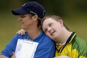 17 June 2005; Special Olympic athletic Karl Rathbourne, Cheeverstown, rests his head on the shoulder of volunteer Theresa Shermer during the game. Special Olympics Ireland Leinster / Eastern Regional Games 2005, Stillorgan Rangers  v Bray Lakers. AUL Complex, Clonshaugh, Dublin. Picture credit; David Maher / SPORTSFILE