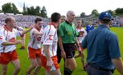 19 June 2005; Tyrone players Peter Canavan, left, and Conor Gormley try to restrain team-mate Ryan McMenamin confronting referee Gerry Kinneavy. Bank of Ireland Ulster Senior Football Championship Semi-Final, Tyrone v Cavan, St. Tighernach's Park, Clones, Co. Monaghan. Picture credit; Pat Murphy / SPORTSFILE