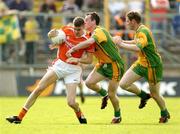 18 June 2005; Philip Loughran, Armagh, in action against Barry Monaghan and Brendan Boyle, right, Donegal. Bank of Ireland Ulster Senior Football Championship Replay, Armagh v Donegal, St. Tighernach's Park, Clones, Co. Monaghan. Picture credit; Pat Murphy / SPORTSFILE