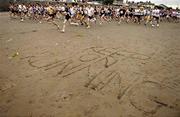 21 June 2005; Words of encouragement are etched in the sand as runners start the ESB BHAA Mid-Summer 5K Beach Race. Sandymount Strand, Dublin. Picture credit; Brian Lawless / SPORTSFILE