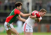 9 February 2014; Peter Hughes, Tyrone, in action against Ger Cafferkey, Mayo. Allianz Football League Division 1 Round 2, Tyrone v Mayo, Healy Park, Omagh, Co. Tyrone. Picture credit: Oliver McVeigh / SPORTSFILE