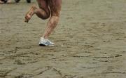 21 June 2005; An athlete continues after losing one runner during the ESB BHAA Mid-Summer 5K Beach Race. Sandymount Strand, Dublin. Picture credit; Brian Lawless / SPORTSFILE