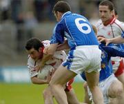 25 June 2005; Davy Harte, Tyrone, is tackled by, Peter Reilly, Cavan. Bank of Ireland Ulster Senior Football Championship Semi-Final Replay, Tyrone v Cavan, St. Tighernach's Park, Clones, Co. Monaghan. Picture Credit; Matt Browne / SPORTSFILE