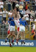 25 June 2005; Conor Gormley, Tyrone, in action against, Nicholas Walsh, left, and Anthony Forde, Cavan. Bank of Ireland Ulster Senior Football Championship Semi-Final Replay, Tyrone v Cavan, St. Tighernach's Park, Clones, Co. Monaghan. Picture Credit; Matt Browne / SPORTSFILE