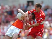 26 June 2005; Martin O'Rourke, Armagh, in action against Padraig Kelly, Derry. Bank of Ireland Ulster Senior Football Championship Semi-Final, Armagh v Derry, Casement Park, Belfast. Picture Credit; David Maher / SPORTSFILE