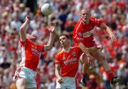 26 June 2005; Tony McEntee, left, and Paul McGrane, Armagh, in action against Patsy Bradley, Derry. Bank of Ireland Ulster Senior Football Championship Semi-Final, Armagh v Derry, Casement Park, Belfast. Picture Credit; David Maher / SPORTSFILE