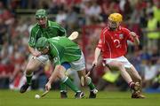 26 June 2005; Seamus Hickey, Limerick, assisted by David Moloney, prepares to clear under pressure from Cathal Naughton, Cork. Munster Minor Hurling Championship Final, Cork v Limerick, Pairc Ui Chaoimh, Cork. Picture Credit; Ray McManus / SPORTSFILE