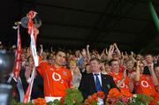 26 June 2005; Cork captain Sean Og O'hAilpin lifts the Munster trophy under the watchful eyes of the President Mary McAleesa and Munster Council Chairman Sean Fogarty. Guinness Munster Senior Hurling Championship Final, Cork v Tipperary, Pairc Ui Chaoimh, Cork. Picture Credit; Ray McManus / SPORTSFILE