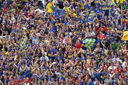 26 June 2005; Tipperary fans cheer on their side during the game. Guinness Munster Senior Hurling Championship Final, Cork v Tipperary, Pairc Ui Chaoimh, Cork. Picture Credit; Ray McManus / SPORTSFILE
