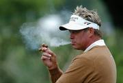 28 June 2005; Darren Clarke smokes a cigar during a break in practice in advance of the Smurfit European Open. K Club, Straffan, Co. Kildare Picture credit; David Maher / SPORTSFILE