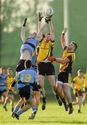 13 February 2014; Brian Fenton, University College Dublin, supported by team-mate Conor Downey, bottom, in action against Tom Flynn and Pete Dooney, right, Dublin City University. Irish Daily Mail HE GAA Sigerson Cup 2014, Quarter-Final, University College Dublin v Dublin City University, UCD, Belfield, Dublin. Picture credit: Pat Murphy / SPORTSFILE