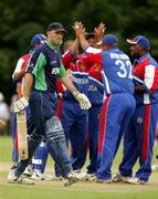 1 July 2005; Ireland's Jeremy Bray leaves the field after being bowled out as Bermuda players celebrate. ICC Trophy, Ireland v Bermuda, Stormont, Belfast, Co. Antrim. Picture credit; Oliver McVeigh / SPORTSFILE