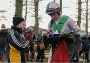 15 February 2014; Jockey Brian O'Connell signs an autograph for Jason Walsh, age 12, from Kilkenny City, after he rode Argocat to win the Red Mills Steeplechase. Gowran Park, Gowran, Co. Kilkenny. Picture credit: Barry Cregg / SPORTSFILE