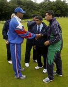 5 July 2005; Ireland captain Jason Molins shakes hands with USA captain Richard Staple in the company of Umpires from left Paddy O'Hara, Shabul Hameed, Indonesia and Asad Raul, Pakistan after the match was abandoned due to rain. ICC Trophy, Group A, Ireland v USA, Warringstown, Co. Down. Picture credit; Damien Eagers / SPORTSFILE