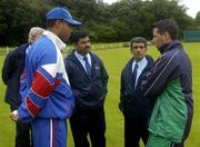 5 July 2005; Ireland captain Jason Molins with USA captain Richard Staple in the company of Umpires from left Paddy O'Hara, Shabul Hameed, Indonesia and Asad Raul, Pakistan after the match was abandoned due to rain. ICC Trophy, Group A, Ireland v USA, Warringstown, Co. Down. Picture credit; Damien Eagers / SPORTSFILE